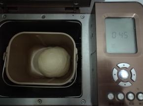 面团内所有材料按照先液体后固体放入面包机，酵母挖坑放在最上面。启动面包机和面程序15分钟，揉成光滑的面团。