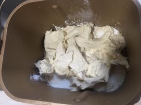将中种面团撕成块放入面包机揉顺滑后再加入黄油继续揉面。