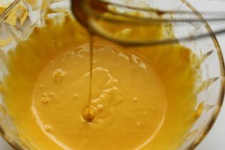 再把蛋黄倒入盆里，再用刮刀搅拌混合均匀就好，混合到流动性的蛋黄糊即可，这样就已经把蛋黄糊做好放一边