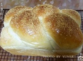 成品。这个是用450克吐司模，编了三股辫子，放烤箱烤的，表面撒了椰蓉。