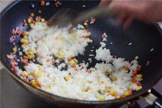 大火爆炒约30秒左右，加入米饭，爆炒的时间不宜过长，否则会丢失原本的香嫩
