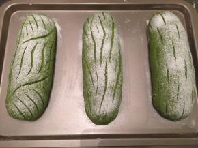 取出面包胚，烤箱预热180度。均匀地在面包胚上筛上干粉，用刀片随意在面包上割出喜欢的花纹