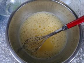 蛋黄内加入盐、玉米油、牛奶，手动打蛋器混合均匀，充分乳化。