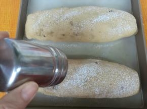 面包坯发酵到两倍大，表面筛低粉。烤箱上下火185度提前预热10分钟。