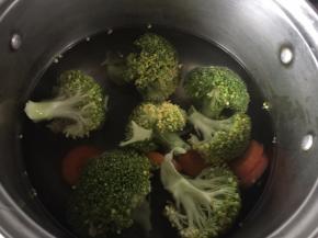 锅里加入适量清水煮开后放入西兰花和胡萝卜片焯熟，焯时加入适量盐和油