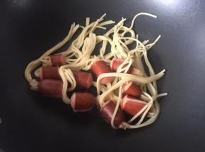 然后将沥干水份的穿肠意面放入锅里将热锅肠煎香，因为煮的时候热锅肠被煮得没有那么香了