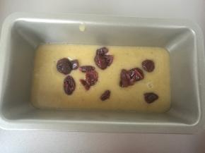 挤入模具内，先挤进去一半面糊，撒入几粒蔓越莓。