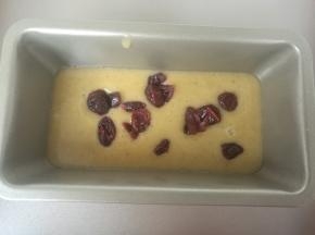 挤入模具内，先挤进去一半面糊，撒入几粒蔓越莓。