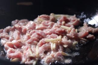 6.锅中放入适量油，油热放入肉丝翻炒均匀
