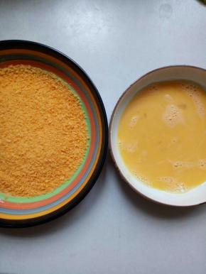 大鸡蛋打散，面包糠倒入盆子里