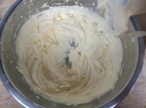 电动打蛋器不开，先搅拌一下防止糖粉飞溅，搅拌均匀后打发至颜色发白体积膨大。
如图。打发过程中若黄油过热，立刻离开温水取出，继续打发。