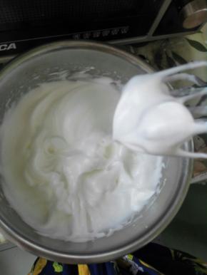 2、打蛋白的盆必须无水无油，滴两滴柠檬汁，把40克糖分三次加入蛋蛋白中打至湿性发泡，如图所示。不要打过头，卷的时候会裂。