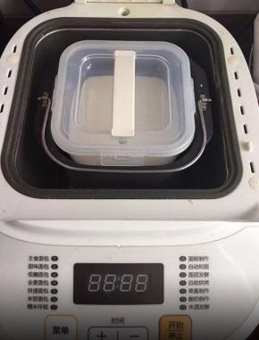 将纯牛奶倒入酸奶桶里，加入益生菌搅拌均匀后放入面包机中