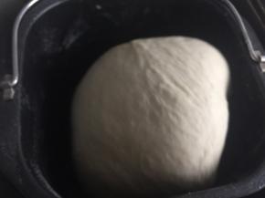 面团搅拌均匀后加入撕小块的黄油一起搅拌均匀