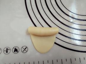 8.取静置好的面团擀成牛舌状  卷起来静置