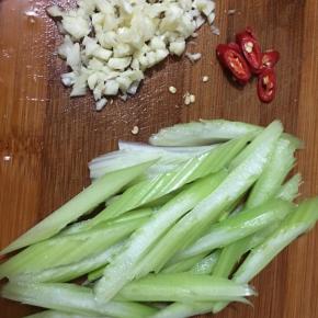 西芹去筋洗净切段，蒜头切碎，小米椒切圈。