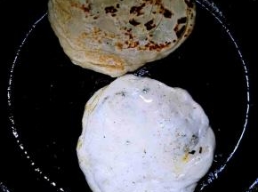 面胚用擀面杖稍擀大一点，烙饼子的锅抹油放入饼子，小火煎黄，翻面，两面都煎黄就可以了，