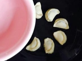 当听到吱吱声倒入清水，漫过饺子底部就可以。