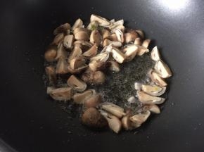 锅里热油后放入草菇炒香
