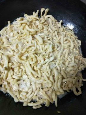 面条放入油中，炸至微微上色发黄就捞出来，不要炸过了