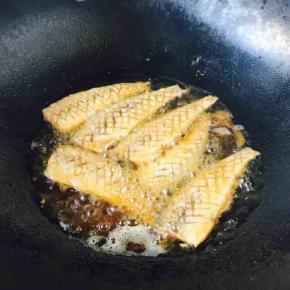 锅里放适量的油，当油温五、六成热时放入马口鱼，把鱼的两面煎至金黄色。