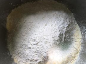 盆中倒入中筋面粉、奶粉、玉米面