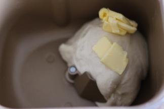 揉至面团光滑后，加入黄油，继续揉。