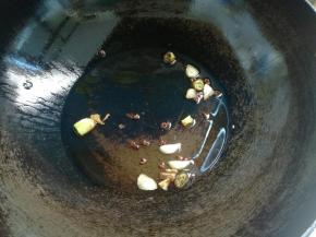 锅烧热放油，放入几粒花椒，蒜片、葱花炸香。