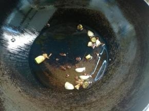 锅烧热放油，放入几粒花椒，蒜片、葱花炸香。