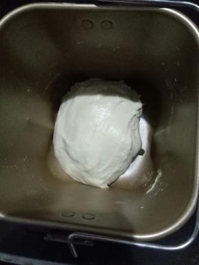 1、把面团部分中除黄油以外的所有材料称量好，放入容器中，启动揉面程序，开启一个和面程序，然后加入黄油，在开启一个和面程序。