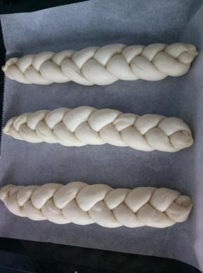 10.	依次编好三根辫子。放入烤盘，整理好形状和位置，开始二次发酵。