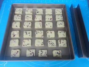 烤箱上下火预热175度。取出饼干面团，切成片状，薄厚要一致，间隔摆在不粘方形盘内（普通盘要垫烘焙纸）