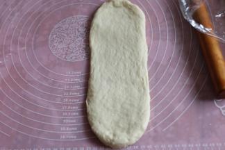 取一个面团，擀成长舌型。