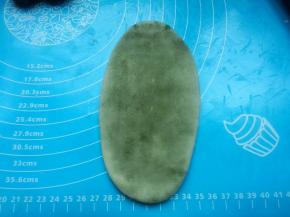 虎口收圆，封口捏紧，擀面杖擀成长舌状。