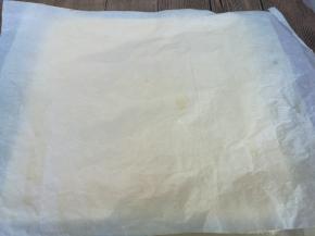 蛋糕晾至手温，用一张干净的油纸或油布盖在蛋糕表面，翻过来，揭去油布，再用油布盖在蛋糕上，再次翻过来，去除油布。