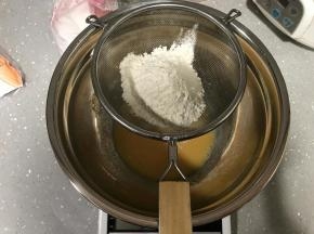 低筋面粉过筛加入。用手动打蛋器搅拌至无粉的状态，尽量不要划圈搅拌，以免低筋面粉起筋