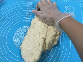 4. 刚开始的面团会很粘，揉面团时可用塑料刮板进行辅助，可以帮助我们把粘在案板上的面团铲下来