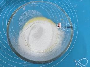 3. 把低筋面粉过筛在蛋黄糊中，用Z字手法把低筋面拌至看不到干粉
