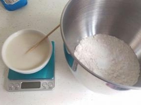 把静止好的酵母水倒入已经称好面粉中。我用厨师机揉，低速揉到表面光滑。如果用手揉也是一样的，揉到3光（盆光，手光，面团光）就可以咯。