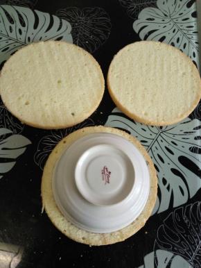 蛋糕片要比模具小一圈，拿个碗盖在蛋糕片上，用力一压，围边拿掉。