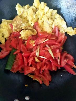 倒入西红柿，葱蒜，一边翻炒