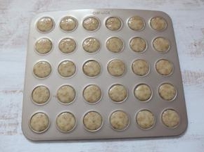 裱花袋剪一个小口，均匀的将面糊挤在不沾烤盘上。