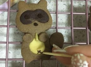 出炉～黑色巧克力放在裱花袋里隔水融化后裱出小熊的眼睛和嘴，小熊的肚子因为比较细，可以用牙签沾黑巧克力画上小叉作为肚脐眼