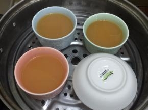 7. 锅里坐水烧开把封好的蛋液放入蒸锅，这一步是最关键的，接下来就要用到保鲜膜来把碗封住，这样是避免蛋液直接接触到水蒸气，保鲜膜包好后用牙签戳几个小孔，我用的是盘子盖