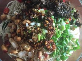 将面捞入碗中，并将花生粒、碎米芽菜、葱花、小米辣（不喜太辣者可不加），白芝麻，辣椒油加入。