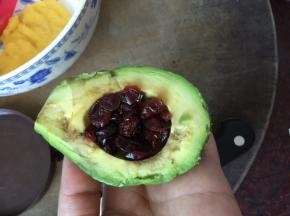 牛油果去皮去核后刷上柠檬汁，然后放入泡发好的蔓越莓