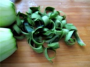 购买小冬瓜，瓜皮及瓜肉都非常的鲜嫩，洗净外皮。用削皮器将瓜皮削下来，要保持一定的长度。