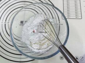 3. 把低筋面从距离盆口10厘高的位置筛入到打蛋盆中搅拌至看不见干粉