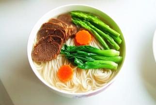 表面铺上刚刚过水的时蔬，再放上几片香味诱人的牛肉片，鲜美香醇的牛肉汤面就做好了，开吃···