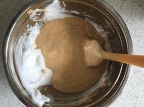 最后把翻拌均匀的蛋糕糊倒入剩下的蛋白霜中，翻拌至完全均匀